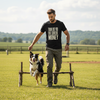 Load image into Gallery viewer, Man walking a border collie dog over a small wooden障碍物 in an open field with trees in the background
