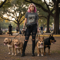 Load image into Gallery viewer, Woman walking four dogs in a park with trees and people in the background