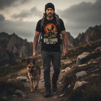 Load image into Gallery viewer, Man hiking with a dog on a mountain path, wearing a t-shirt with a graphic design.