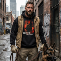 Load image into Gallery viewer, Man in a hoodie with a graphic design and text, standing in an urban alleyway with a german shepherd on a leash.